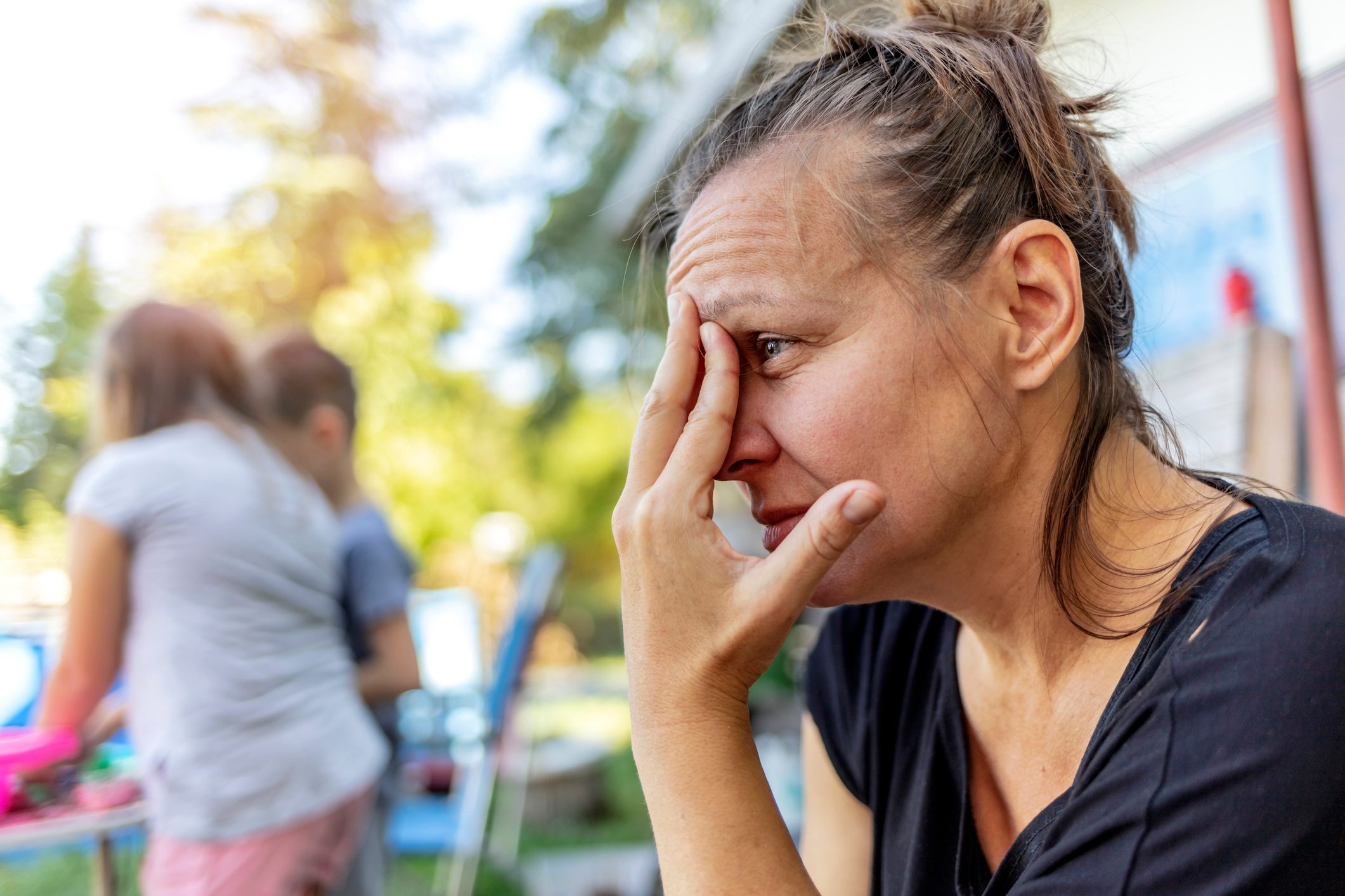 Woman in pain with hands on face